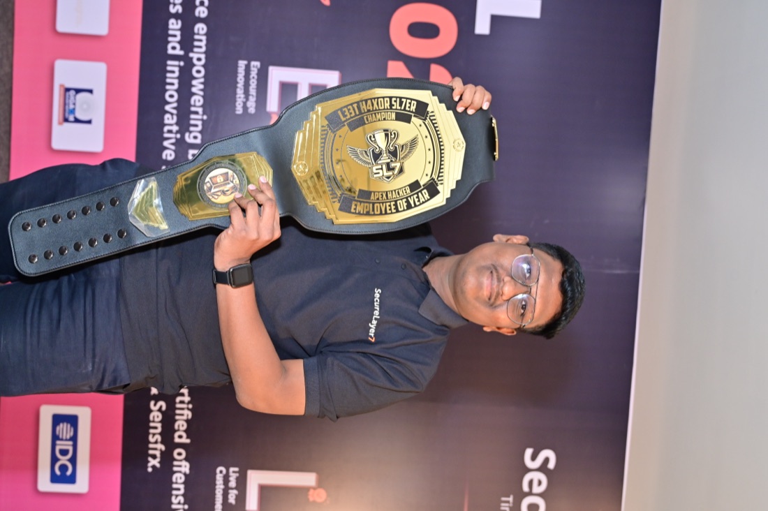 Pranav Khune holding the SecureLayer7 Employee of the Year championship belt at Annual Event 2026