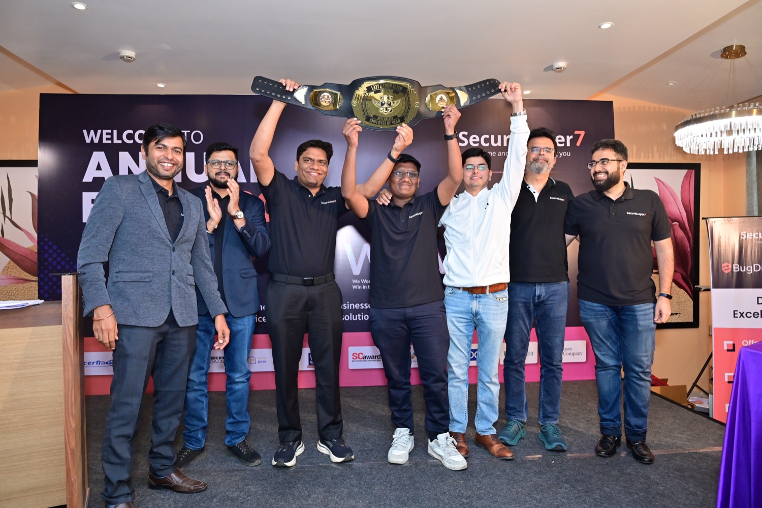 SecureLayer7 leadership team hoisting the Employee of the Year belt at Annual Event 2026